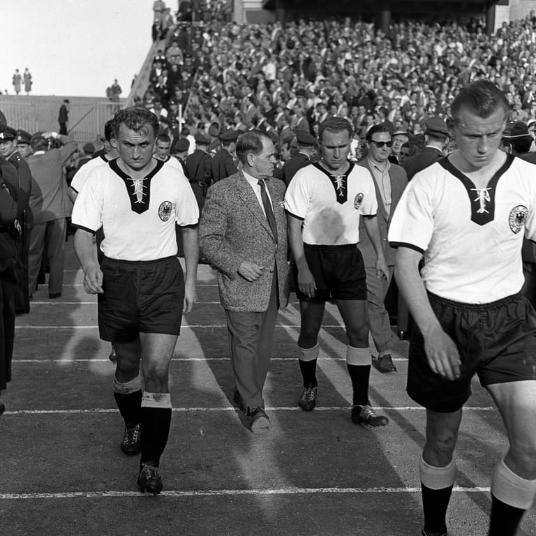 Uli Biesinger (rechts) läuft für das deutsche Nationalteam ein: Der Spieler durfte 1954 ohne Länderspiel-Erfahrung mit zur WM in der Schweiz.