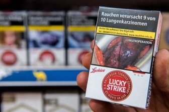 Zigarettenschachtel mit Schockfoto einer Lungenoperation und Warnhinweis.