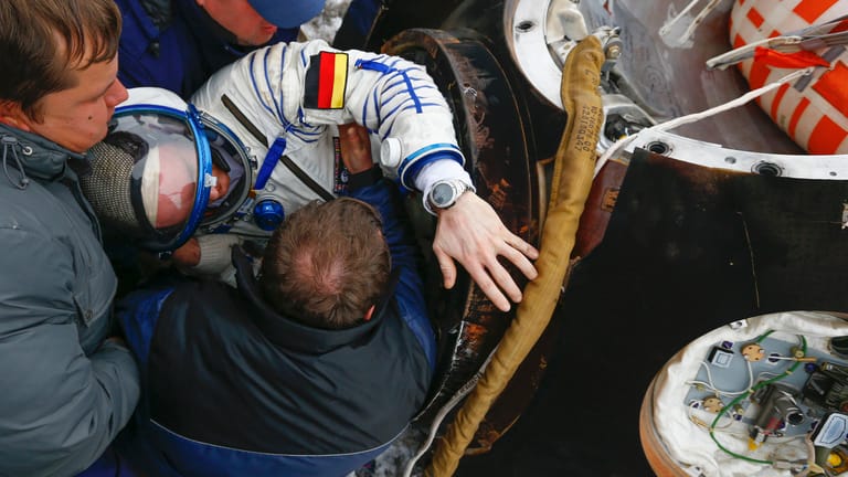 Überstanden: Mitarbeiter vom Weltraumbahnhof Baikonur heben Alexander Gerst nach der Landung in der kasachischen Steppe aus der Raumkapsel.