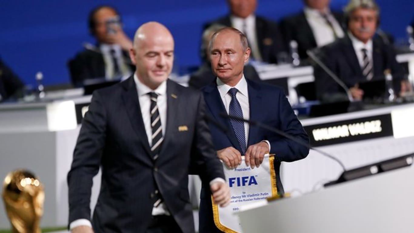 Russlands Präsident Wladimir Putin (r) verspricht allen WM-Gästen ein wunderbares Ereignis.