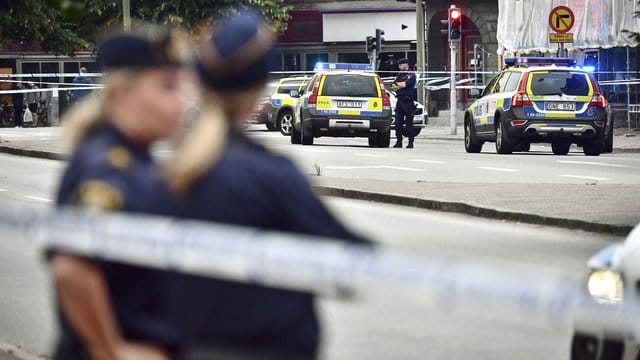 Polizisten sichern eine Straße im schwedischen Malmö. Polizisten sichern eine Straße im schwedischen Malmö.