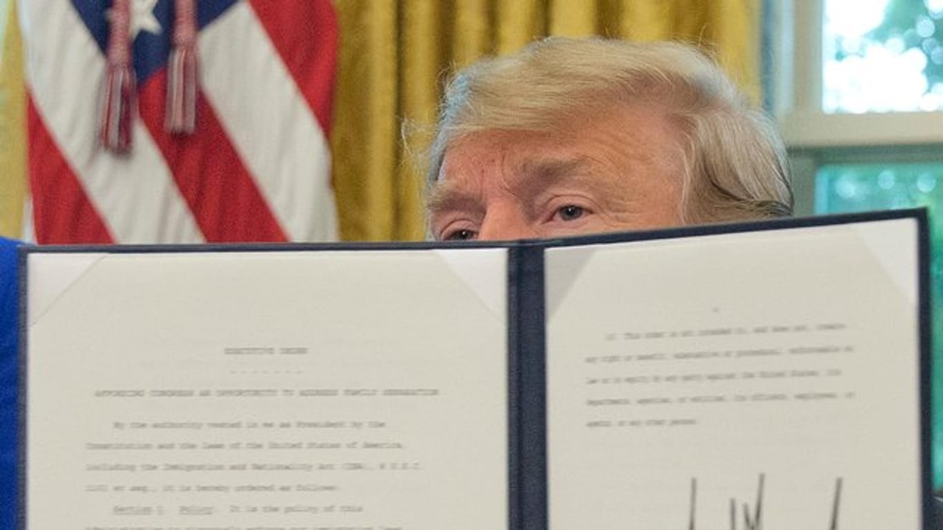US-Präsident Donald Trump zeigt das Dekret, mit dem die von seiner Regierung selbst begonnene Trennung illegaler Einwanderer von ihren Kindern beendet werden soll.
