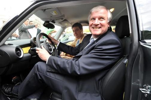 Horst Seehofer und Markus Söder auf einem Archivbild auf Fahrer- und Beifahrersitz eines Elektroautos.