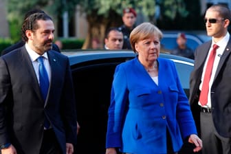 Saad Hariri, Ministerpräsident des Libanon, holt Bundeskanzlerin Angela Merkel (CDU) zur Begrüßung an ihrem Wagen ab: Ihre Reise soll auch in stürmischen Zeiten nach politischer Normalität aussehen.