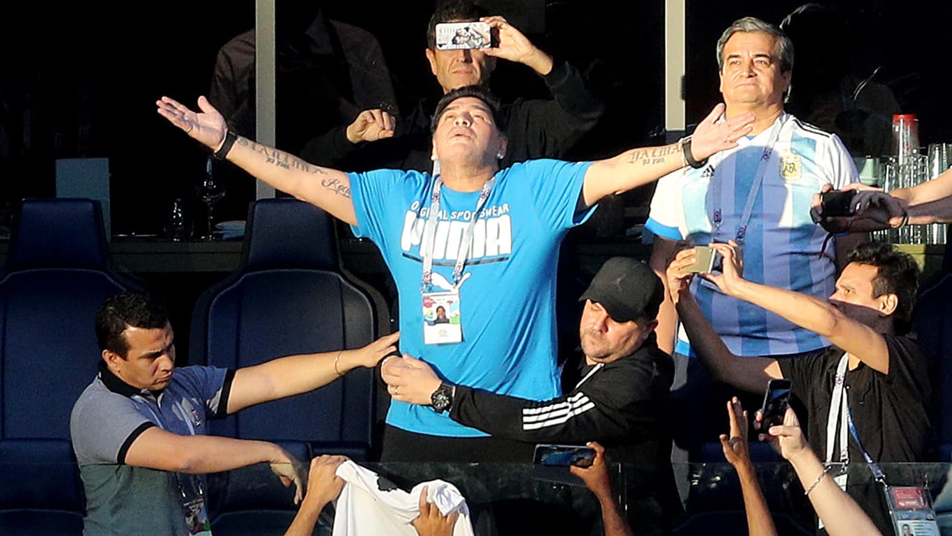 Diego Maradona vor Spielbeginn auf der Tribüne: Ein Helfer hält den Ex-Fußballprofi fest.