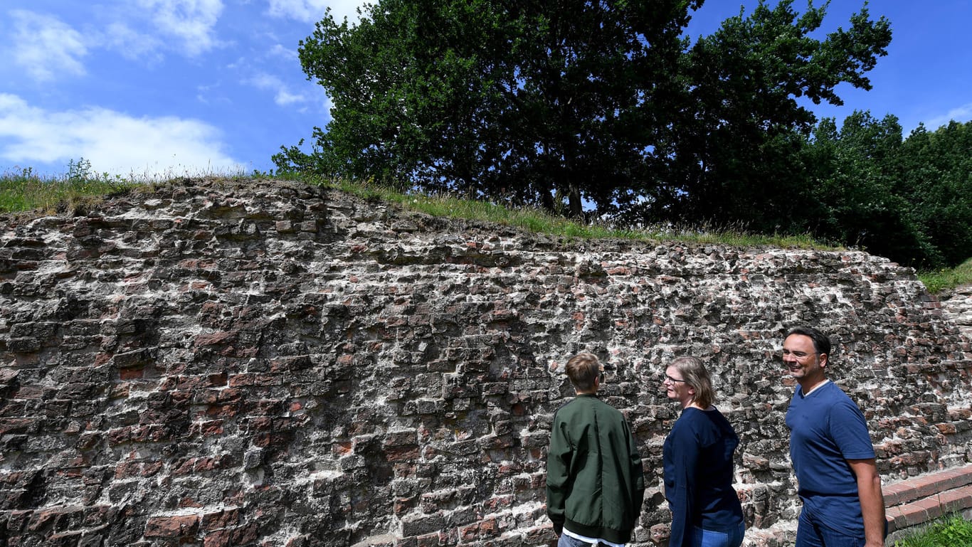 Danewerk: Besucher stehen an der Waldemarmauer des Wikingerortes.