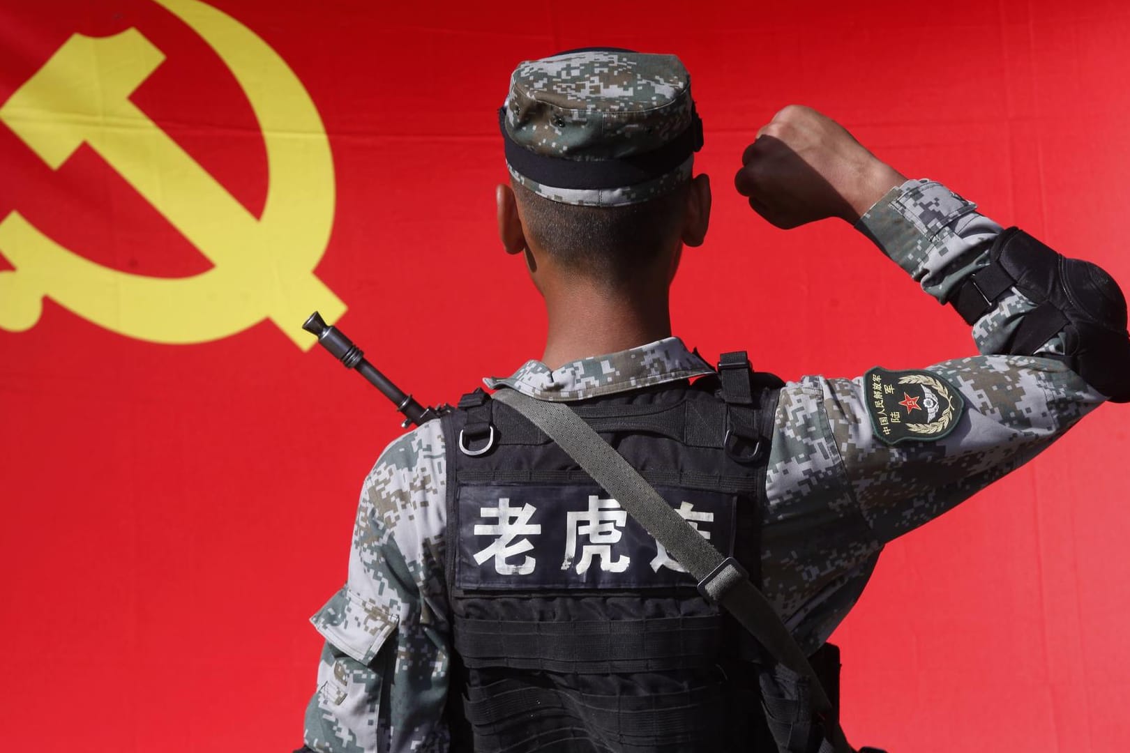Ein chinesischer Soldat vor der Flagge: In Europa setzt China seinen Einfluss mit wirtschaftlichen Mitteln durch.