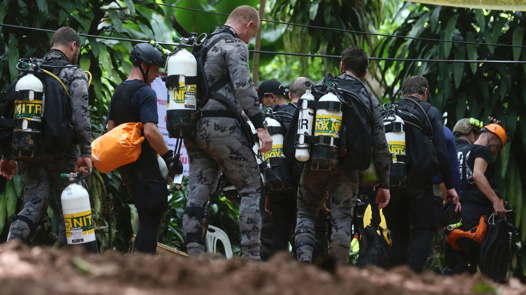 Taucher eines Rettungsteams vor dem Eingang der Höhle, in dem Jugendliche und ihr Trainer eingeschossen sind: Die Eingeschlossenen bekamen schon ersten Tauchunterricht, um die Höhle in Begleitung von Tauchern verlassen zu können.