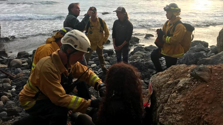 Rettungskräften verarzten Angela Hernandez: Eine Frau überlebte nach einem Klippensturz nur, weil sie sich mithilfe eines Kühlerschlauchs mit Wasser versorgen konnte.