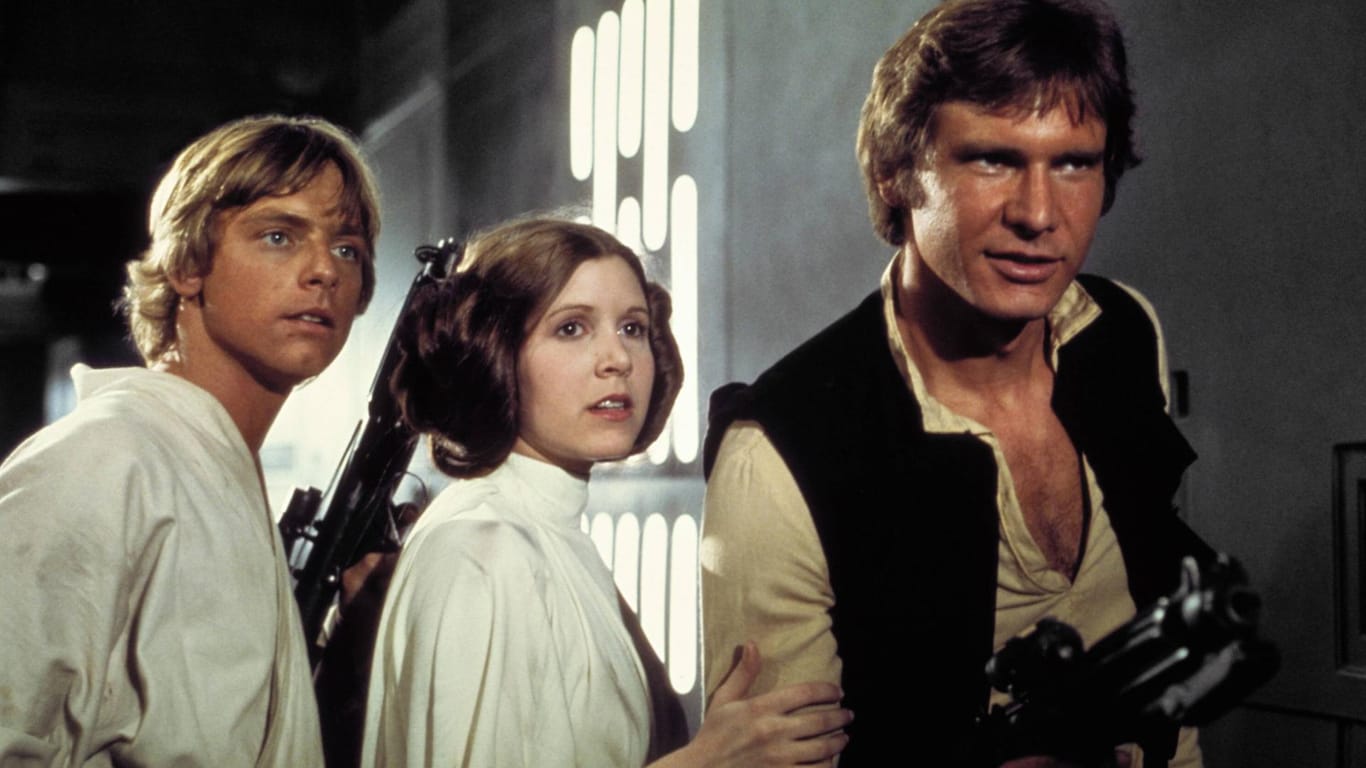 1977: Carrie Fisher mit Harrison Ford und Mark Hamill.