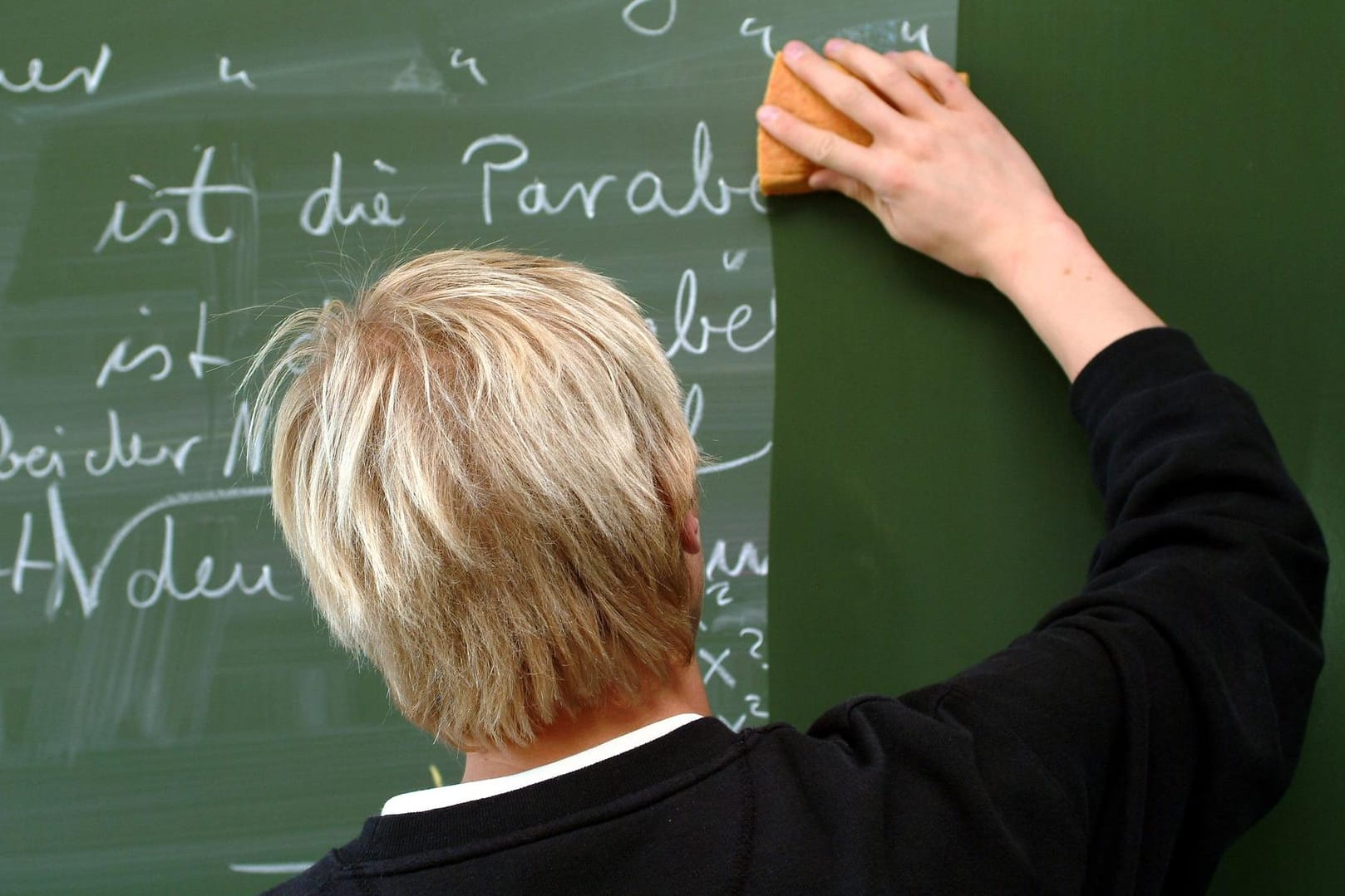 Ein Lehrer wischt die Tafel sauber: Derzeit sind rund 10.000 Lehrerstellen unbesetzt – und das trotz der vielen Quereinsteiger. (Symbolbild)