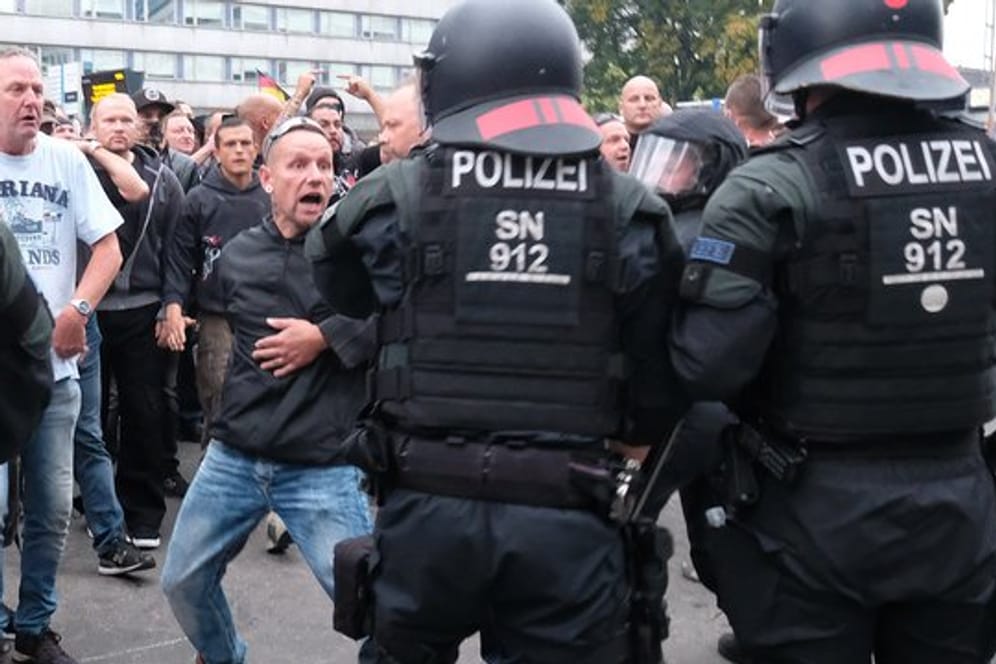 Wutverzerrtes Gesicht: Polizisten versuchen in der Chemnitzer Innenstadt, ein Aufeinanderprallen von rechten und linken Gruppen zu verhindern.