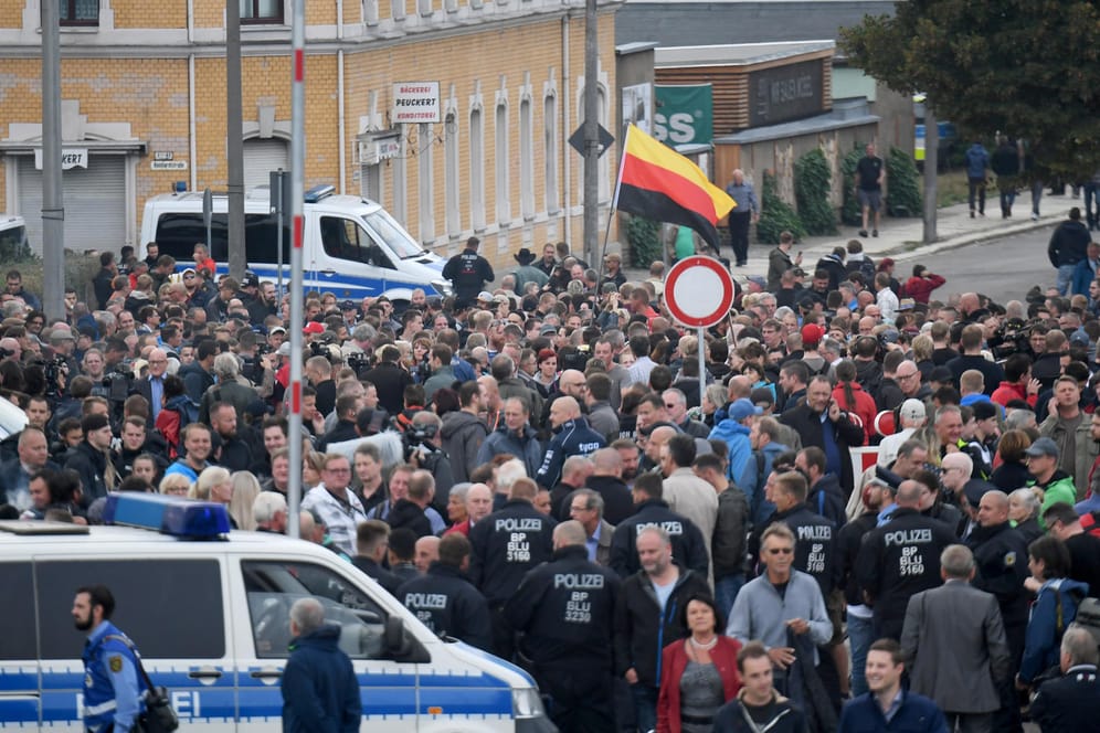 Chemnitz, Donnerstagabend: Demonstranten mit einer Deutschlandfahne versammeln sich vor dem Stadion vom Chemnitzer FC.
