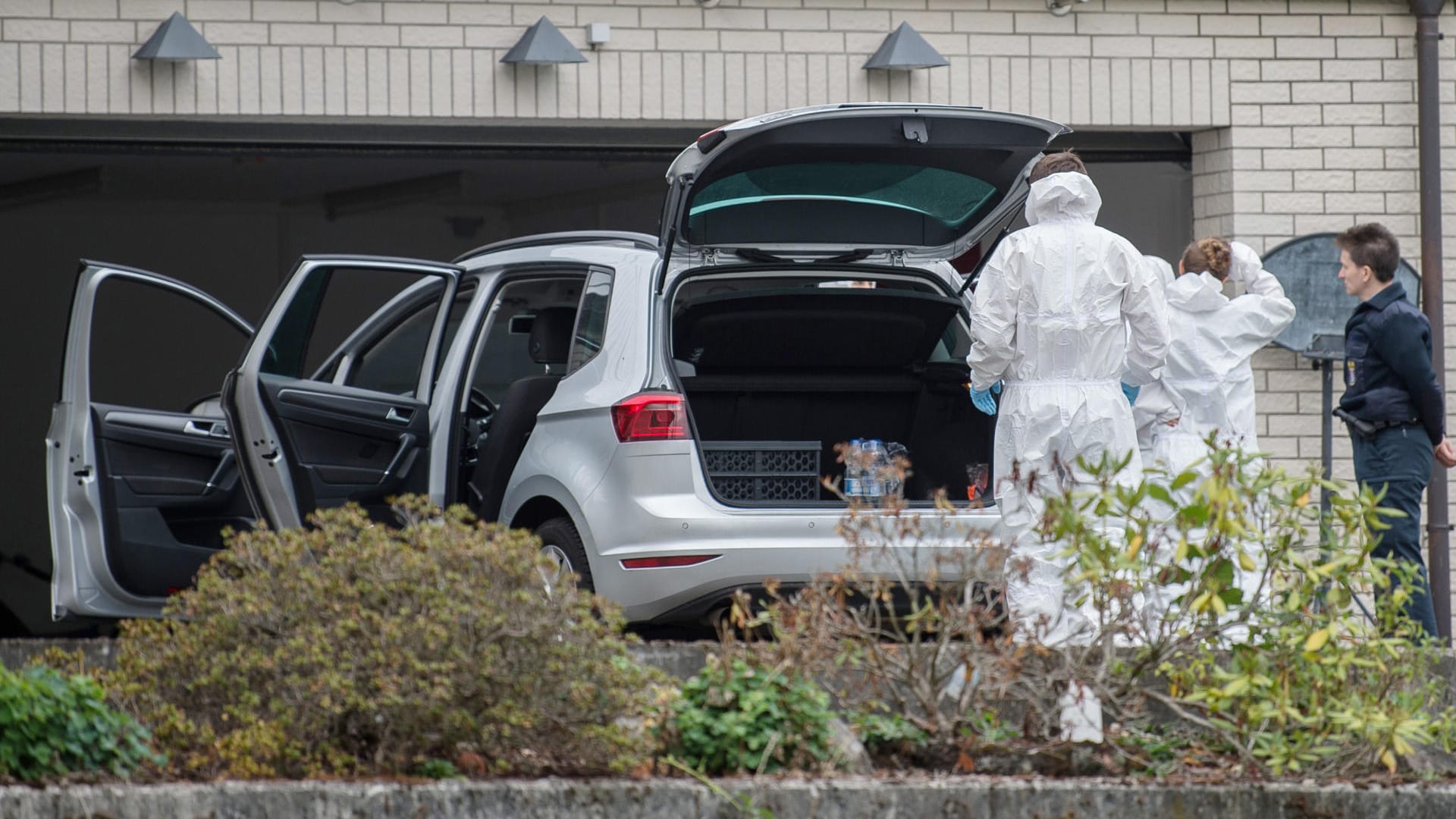 Mitarbeiter bei der Spurensicherung: In der Garage konnten die Eltern der Kinder geborgen werden. Sie befinden sich derzeit im Krankenhaus.