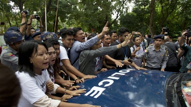 Journalisten und Aktivisten versuchen ein Polizeiauto zu blockieren, in dem die beiden verurteilten Reuters Journalisten sitzen.