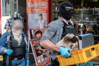 Razzia in Berlin: Beamte der Polizei bringen sichergestellte Gegenstände nach einer Razzia in einer Wohnung eines Mitglieds einer arabischen Großfamilie zu ihrem Auto. Ermittelt wird unter anderem wegen des Verdachts des Verstoßes gegen das Waffengesetz.
