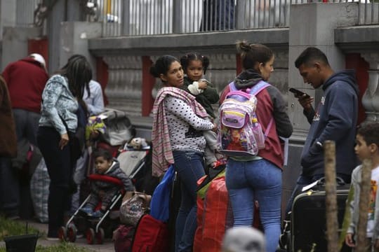Venezolanische Migranten warten auf dem Gelände der Botschaft ihres Landes auf einen Bus, der sie zum Flughafen bringt.
