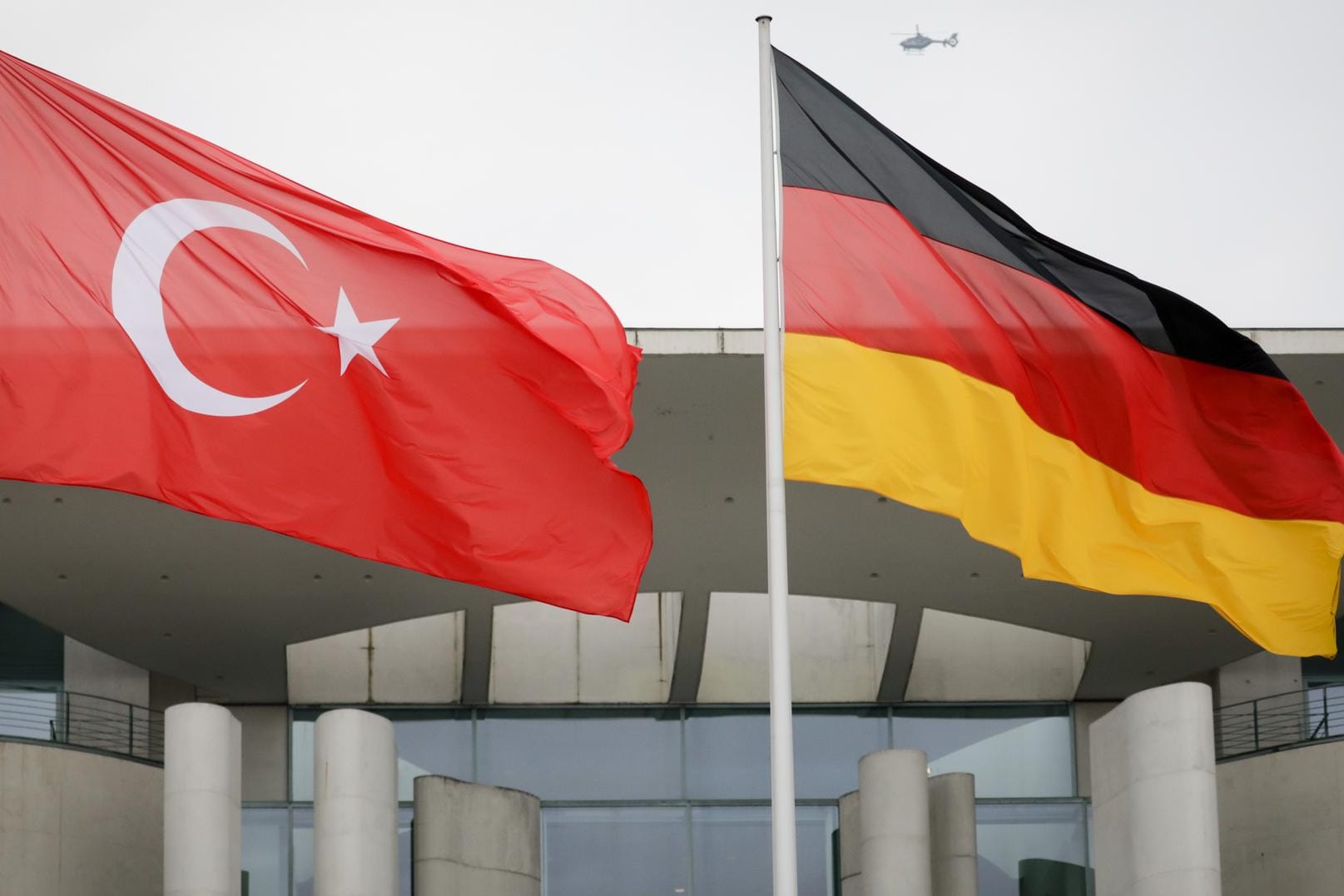 Die türkische und die deutsche Fahne wehen vor dem Bundeskanzleramt: Ein Deutscher ist in der Türkei wegen Terrorpropaganda verurteilt worden.