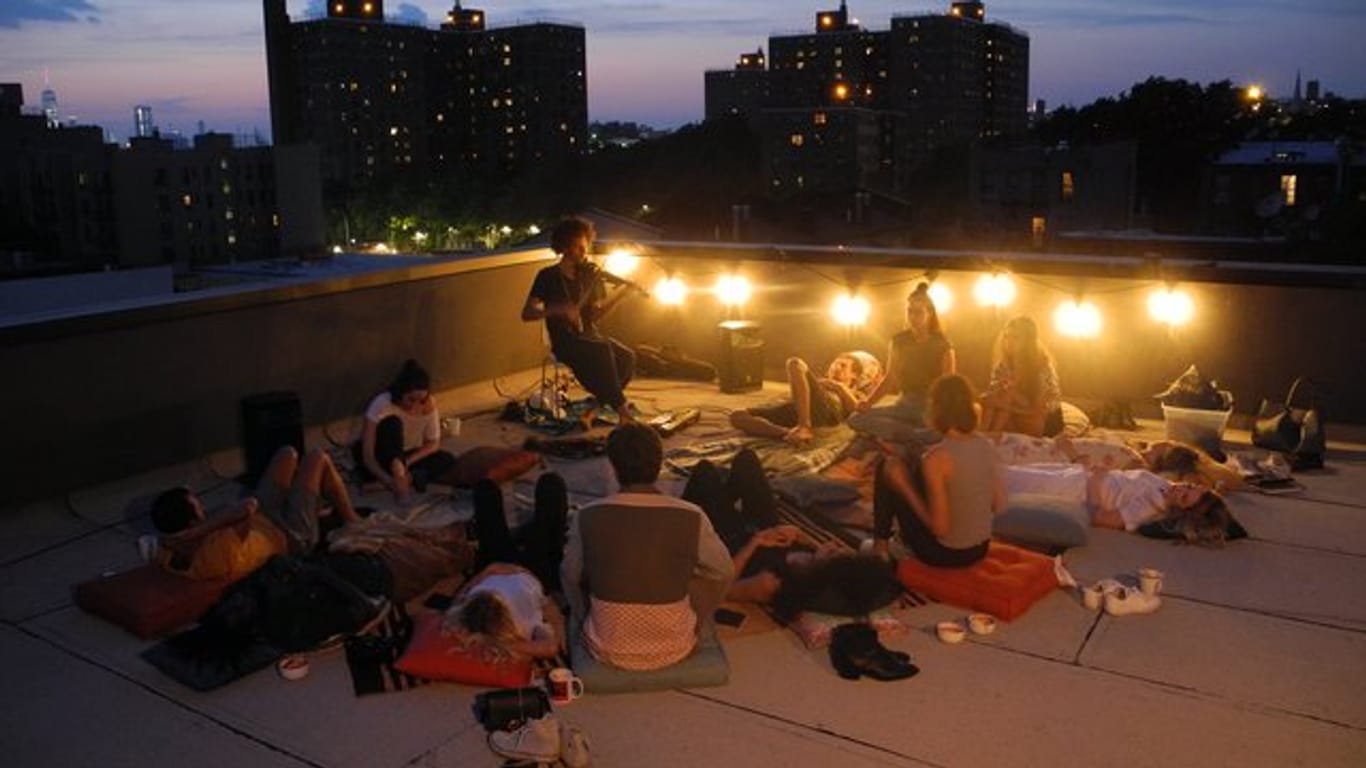 Der Geiger Andrei Matorin (Mitte, hinten) spielt vor Gästen auf seinem Dach in New York.