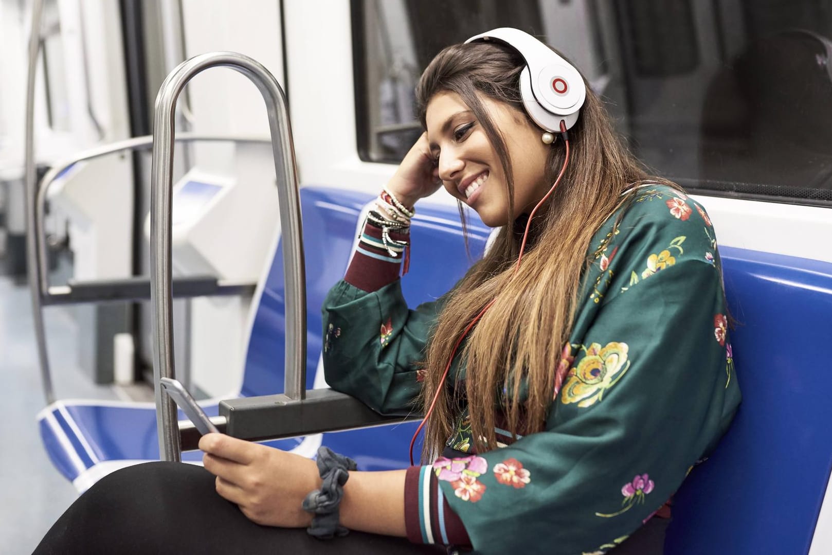 Junge Frau mit Kopfhörern in der U-Bahn: Jeder Zweite nutzt Musik-Streaming-Angebote.