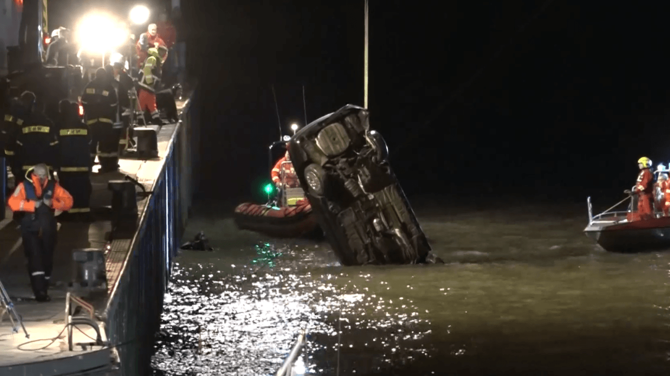 Rettungskräfte bergen das Wrack des ins Hafenbecken gerollten Autos: Die Fahrerin konnte nur noch tot geborgen werden.