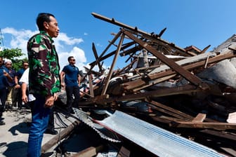 Der indonesische Präsident Joko Widodo geht durch eine beschädigte Gegend: Bei der Tsunami-Katastrophe in Indonesien sind vermutlich mehr als tausend Menschen ums Leben gekommen.