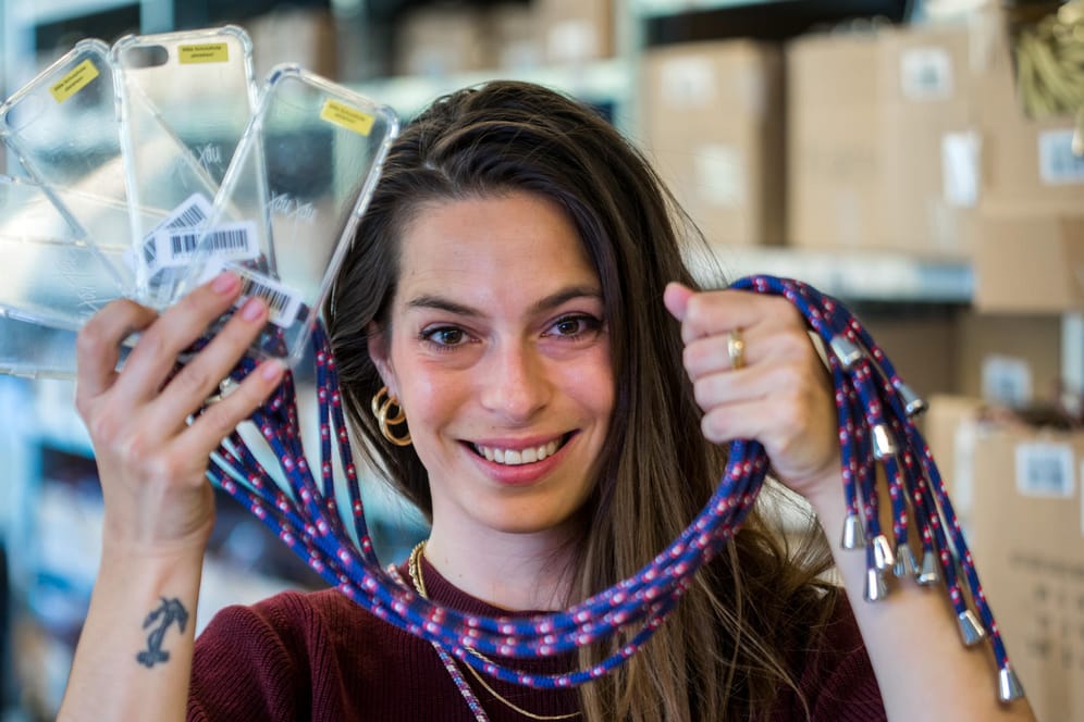Yara Jentzsch Dib zeigt in der Werkstatt einige der von ihr entwickelten Handykordeln: Damit kann man sein Smartphone griffbereit um den Hals tragen.