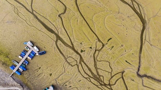 Der See ist weg: Auf dem Trockenen liegen Boote am Ufer des ausgetrockneten Lac des Brenets in der Schweiz. Der See ist weg: Auf dem Trockenen liegen Boote am Ufer des ausgetrockneten Lac des Brenets in der Schweiz.