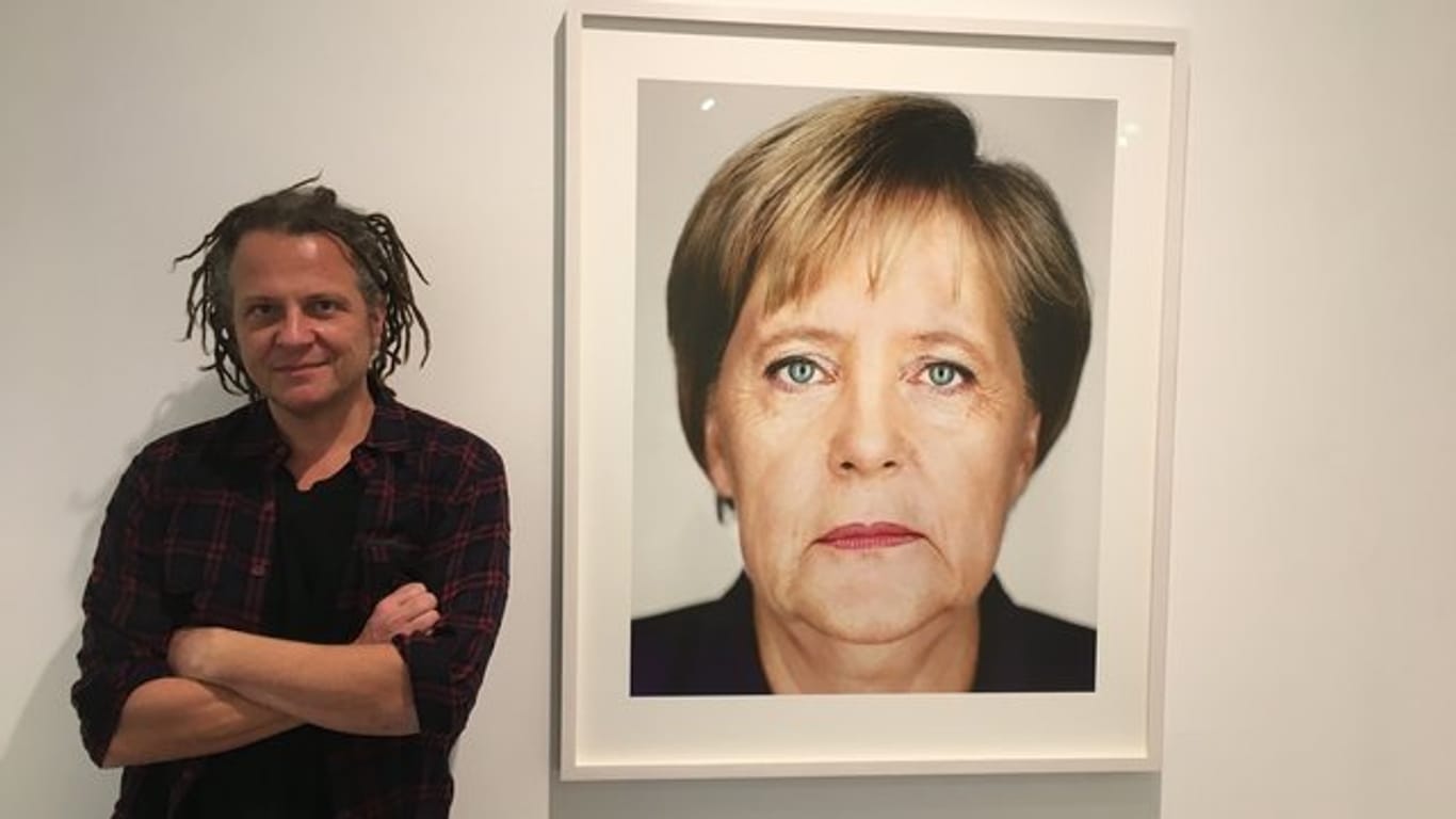 Der Fotograf und sein Bild: Martin in der Wiener Galerie "Ostlicht" neben einem Porträt von Angela Merkel.