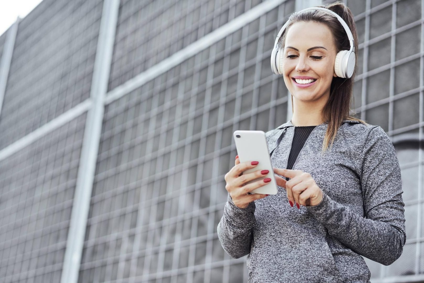 Eine Frau streamt Musik über ihr Smartphone: Die Telekom hat weitere Partner in ihr Streaming-Angebot "StreamOn" aufgenommen.