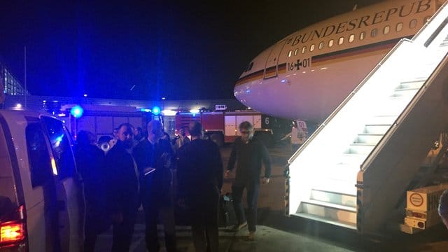 Passagiere stehen auf dem Rollfeld des Flughafens in Köln neben dem Kanzler-Airbus "Konrad Adenauer".