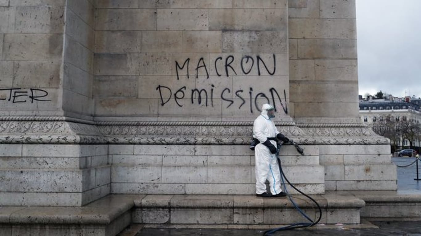 Ein Arbeiter der Stadtreinigung beseitigt Grafitti von einer Wand des Arc de Triomphe.