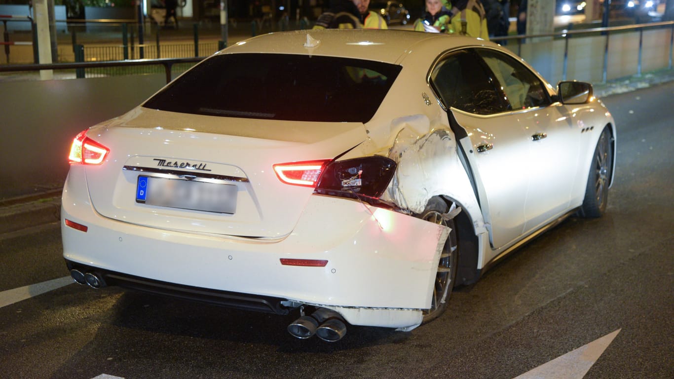 Polizisten stehen neben dem beschädigten Sportwagen auf dem Friedrichsring: Rund 100.000 Euro Sachschaden verursachte der Unfall.