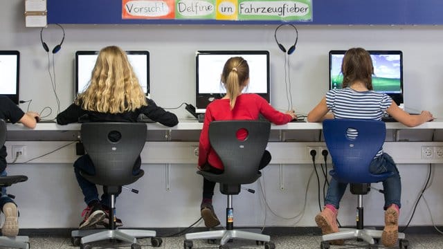 Schüler arbeiten im Klassenraum einer Grundschule an Computern.