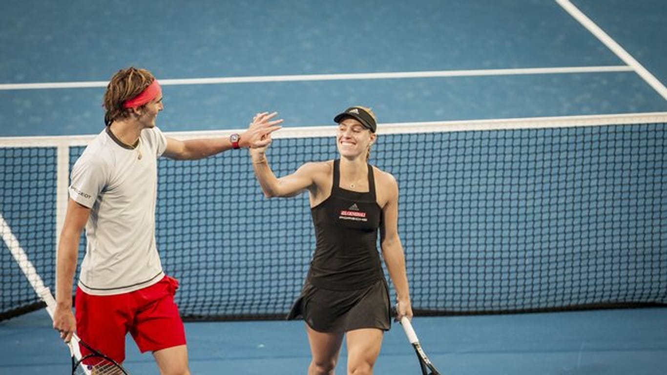 Alexander Zverev (l) und Angelique Kerber klatschen nach dem Sieg im Mixed ab.