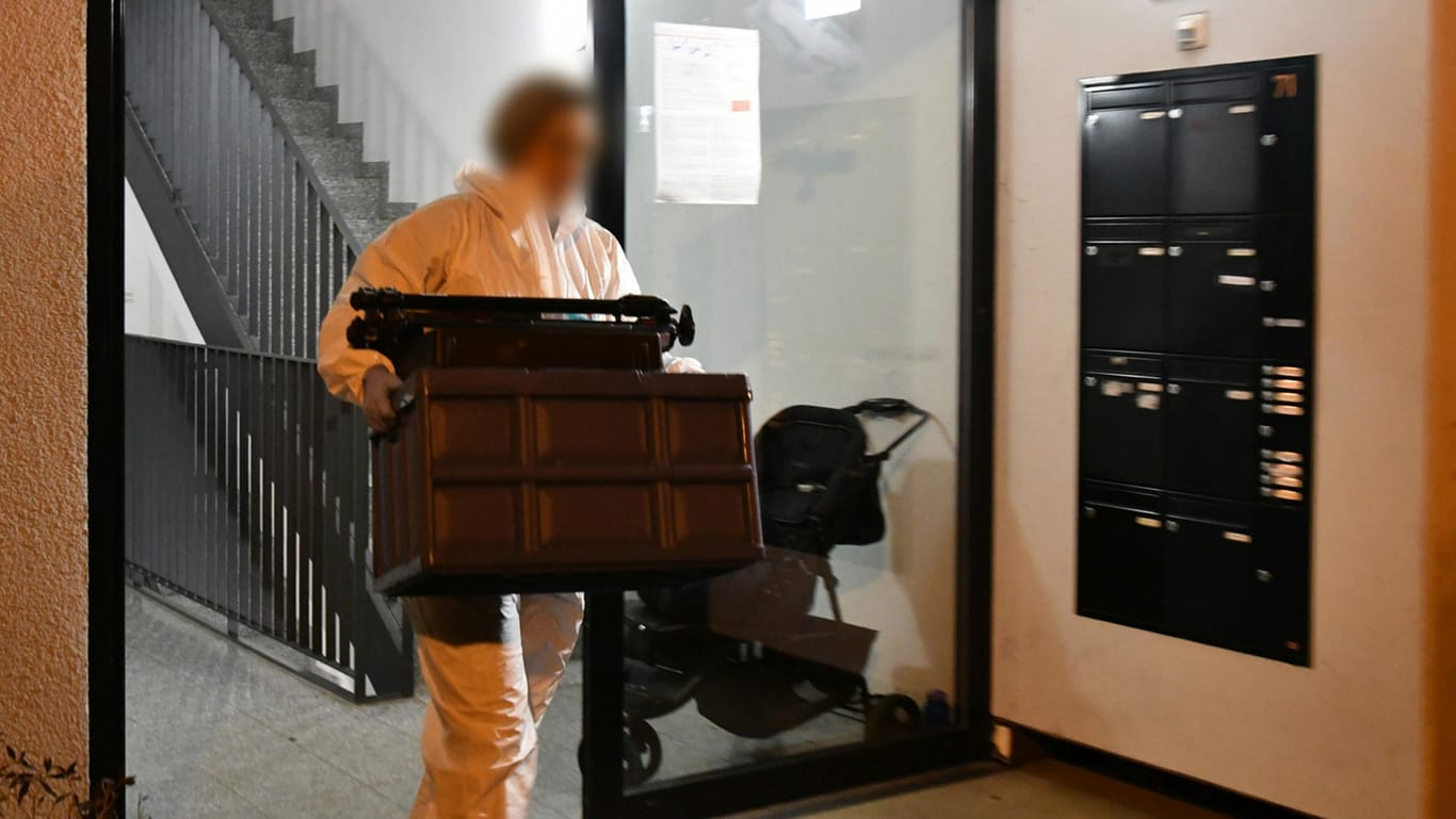 Leichenfund in einer Wohnung in Darmstadt: Eine Mitarbeiterin der Spurensicherung trägt einen Kasten aus dem Haus im Stadtteil Eberstadt.