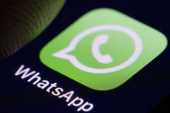 Das Logo des von WhatsApp auf einem Smartphone: iOS-Nutzer können vier neue Funktionen des Messengers testen.