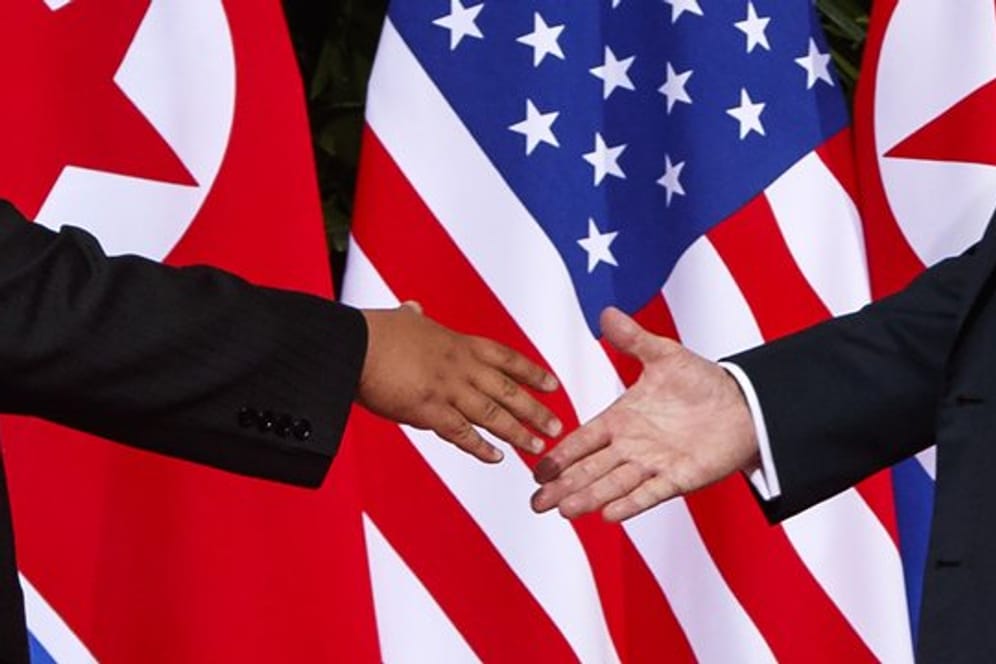 US Präsident Donald Trump (r) streckt dem nordkoreanischen Machthaber Kim Jong Un die Hand bei ihrem Treffen im Capella Resort auf der Insel Sentosa entgegen.