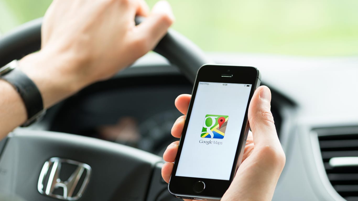 Ein Autofahrer startet die Google Maps-App: Der Routenplaner zeigt künftig Tempolimits und Radarfallen an.