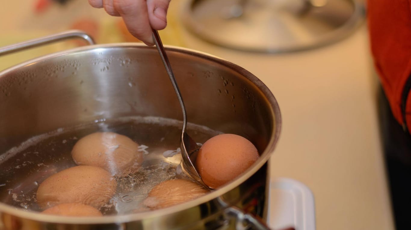 Eier in einem Topf: Heben Sie die Eier mit einem Löffel aus dem Wasser, damit Sie sich nicht verbrennen.