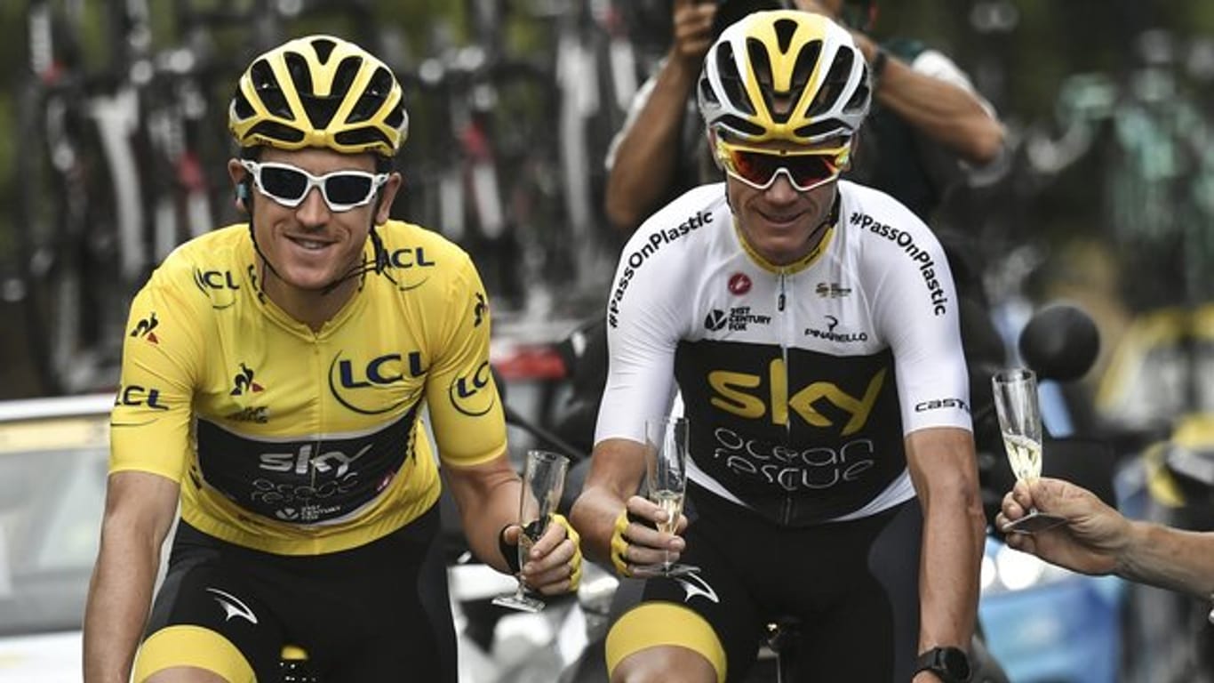 Geraint Thomas (l) fährt im Gelben Trikot des Gesamtführenden auf der letzten Etappe der Tour de France 2018 neben Chris Froome.