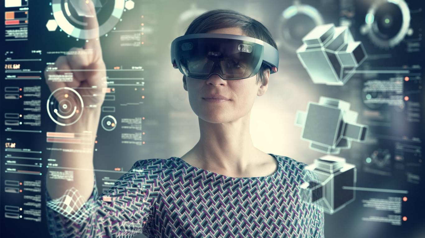 Woman wearing mixed reality smartglasses touching transparent screen model released Symbolfoto prope