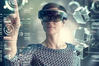Woman wearing mixed reality smartglasses touching transparent screen model released Symbolfoto prope
