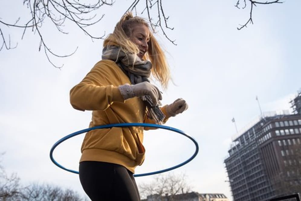 Mehr als nur ein Kinderspiel: Auch Erwachsene können mit dem Hula-Hoop-Reifen Rumpfkraft und Bauchmuskulatur trainieren.
