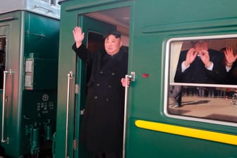 Kim Jong Un (links): Auf diesem von der Regierung Nordkoreas zur Verfügung gestellten Foto winkt der Machthaber aus dem Zug, bevor er Richtung Vietnam fährt.