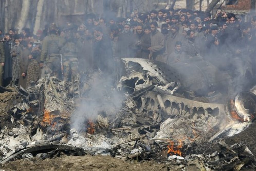 Kaschmirische Dorfbewohner versammeln sich bei den Trümmern eines indischen Kampfflugzeuge im Bezirk Budgam im indischen Teil Kaschmirs.