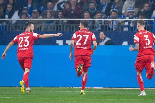 Die Düsseldorfer Niko Gießelmann, Dawid Kownacki und André Hoffmann (l-r) feiern den vierten Treffer auf Schalke.