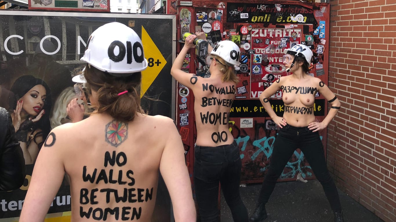 Aktivistinnen von Femen in Hamburg: Mit nacktem Oberkörper und einer Flex demontieren sie im Rotlichtviertel von St. Pauli einen Sichtschutz der Herbertstraße.