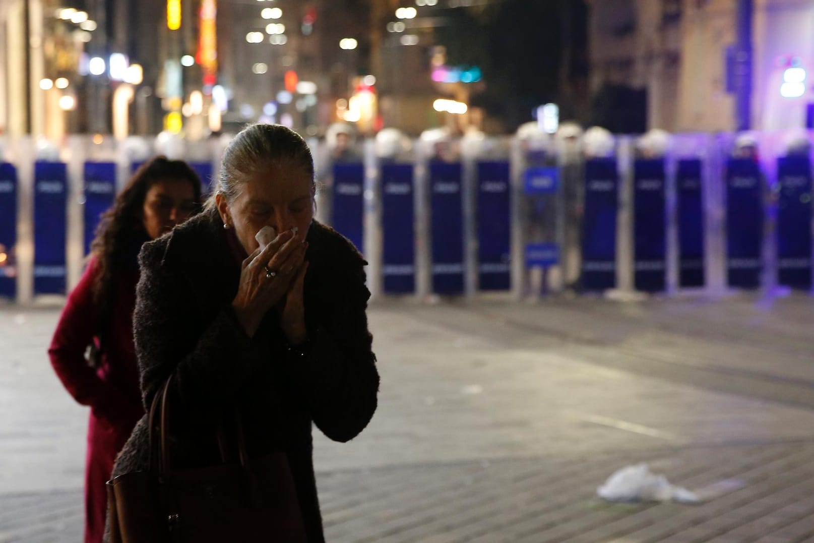 Eine Frau hält sich ein Taschentuch vor Mund und Nase, um sich vor dem Tränengas der Polizei zu schützen: In der Einkaufsstraße Istiklal stoppt die Polizei die Demonstranten zum Internationalen Frauentag.