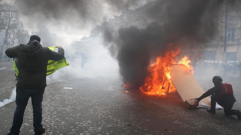 Demonstranten setzen eine Barrikade auf dem Champs-Élysées in Brand: Bei den "Gelbwesten"-Protesten ist es zu Ausschreitungen gekommen.
